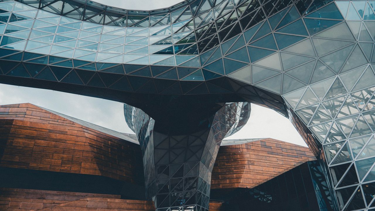 journey Dynamic view of a modern architectural structure featuring glass and steel elements.